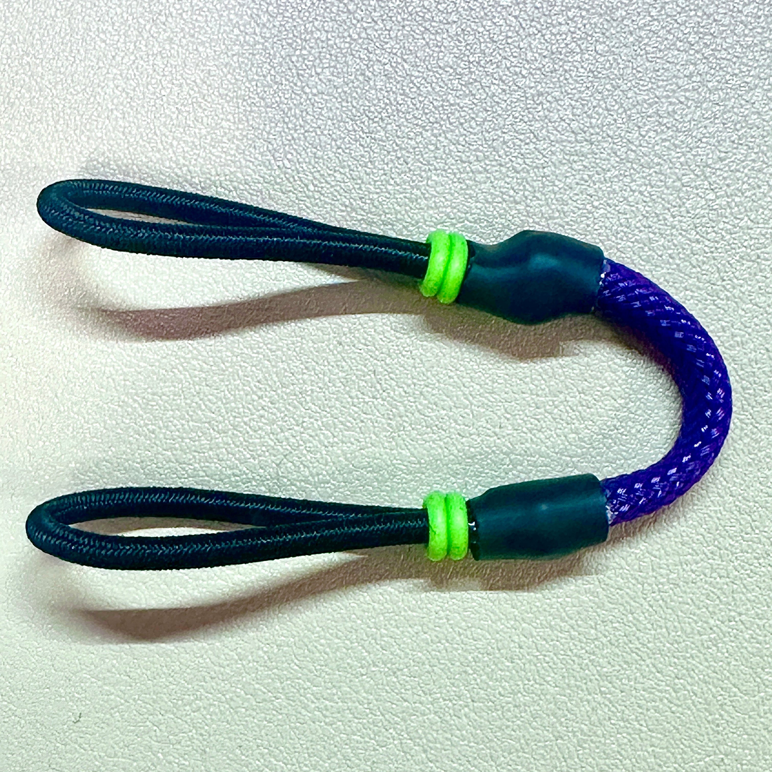 Handmade paracord simple tether with elastic ends on neutral background